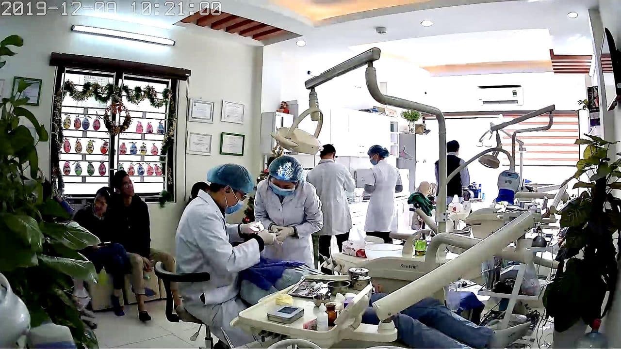 Clinical team treating patients in a modern Hanoi dental clinic