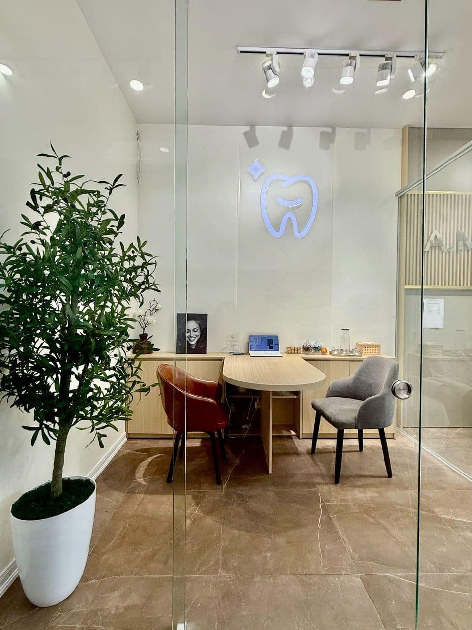 Dentist and patient in an AM Procare treatment room with overhead light and modern equipment